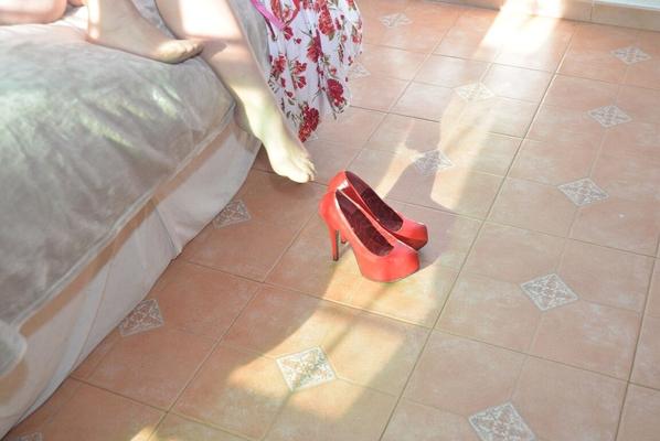 16P Older blonde Melody removes her high heels while getting naked on a bed