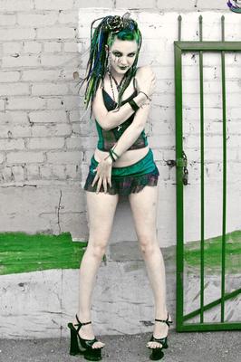 15P Alt girl Scar 13 places hands over her boobs while against a brick wall