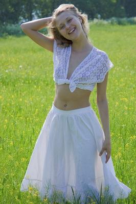 15P Young blonde Pocahontas flashes in a field while wearing see thru clothing