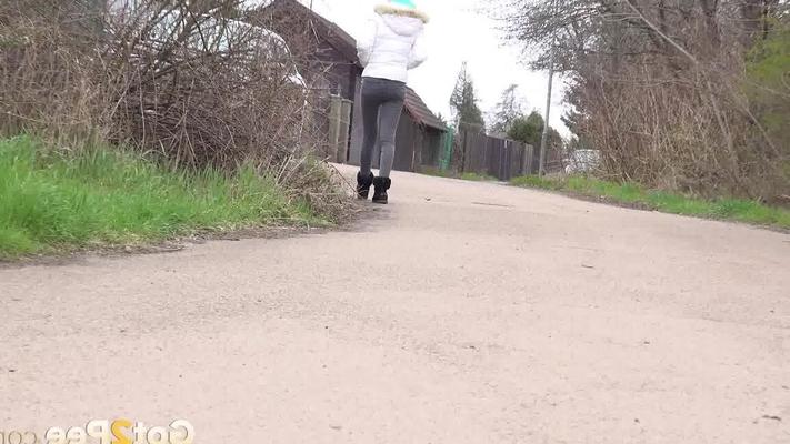 15P Clothed girl Mistica squats for a pee beside the road in winter clothing