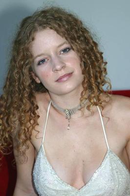 16P Amateur model with long curly hair uncovers big naturals as she strips naked
