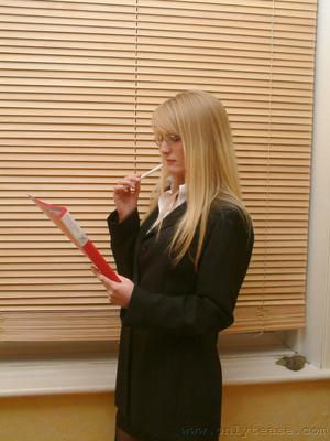 21P Skinny office doll Sharon strips by the window and poses in lingerie