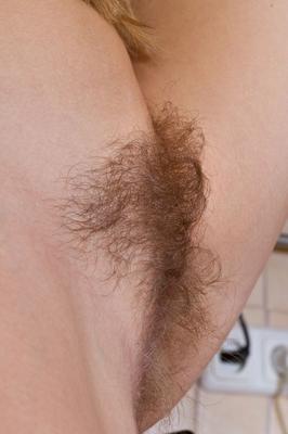21P Hot MILF in a yellow outfit Chloe B flaunts her hairy pussy in a kitchen strip