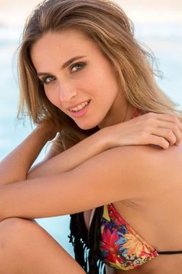 16P Pretty teen Rena doffs a bikini for a nude shoot on a patio by the pool