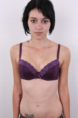 20P Dark haired amateur Michaela exposes her tramp stamp during her nude debut