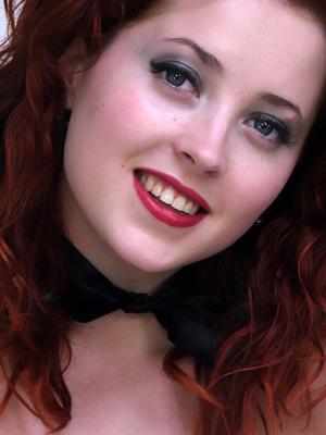 17P Redhead pinup model releases nice tits from sexy black brassiere