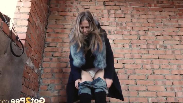 15P Distressed girl squats for an outdoor piss while wearing a heavy winter coat