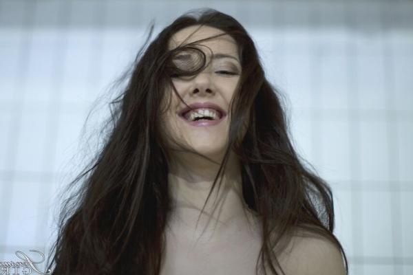 10P Solo girl Patricia Sun piles her long hair on her head in black stockings only