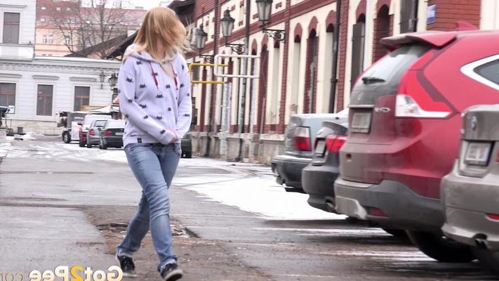 15P Blonde girl Violette squats for a pee between parked cars in the winter