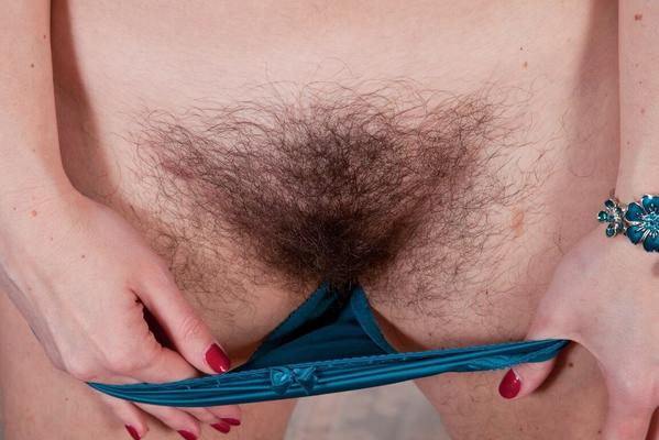 16P Solo girl with brunette hair unveils her full bush as she strips on sofa