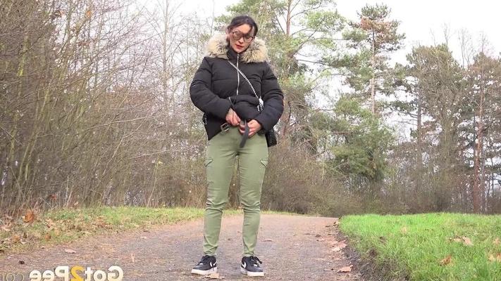 15P Clothed female Natasha Ink holds down her pants for a piss on a rural road