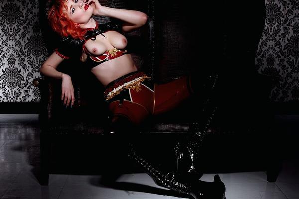 21P Redhead hottie Ulorin Vex shows her tiny boobs and poses in leather high heels