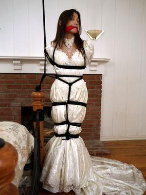 15P Brunette bride Celeste Star is ballgagged and tied up in her wedding dress