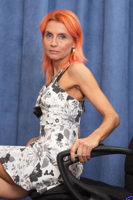 21P Skinny mature with orange hair Philana reveals her small tits & toys her twat