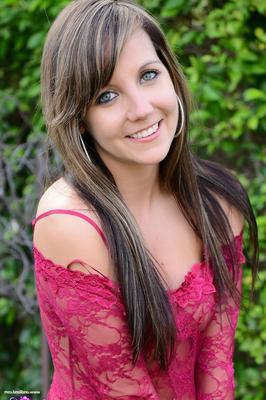 15P Amateur model Andi Land shows her tits before pulling down a thong in a yard