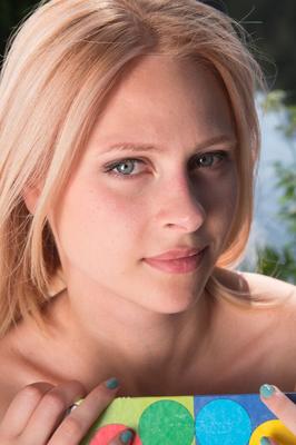 20P Young blonde Emma exposes her bald slit while getting naked near a river