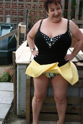 16P Fat older woman Kinky Carol flashes her bra and upskirt underwear on a patio