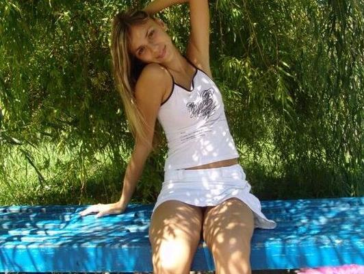 15P Young looking amateur wears no underwear underneath her short skirt