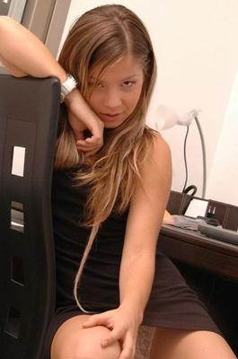 15P Charming young girl uncovers her perky titties at her computer desk