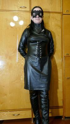 16P Collared solo woman models leather clothing while wearing a mask
