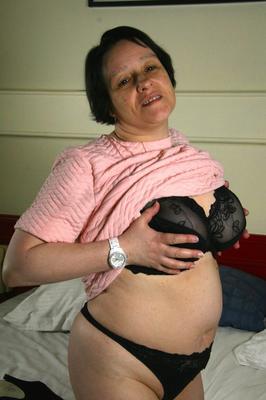 16P Fat older woman undresses on her bed before toying her pussy on a bed