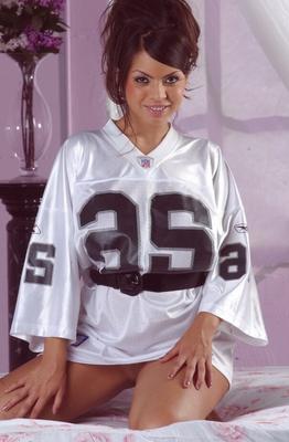 15P Sexy Latina chick Yuri Luv frees her great tits and booty from football jersey