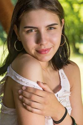 18P Young brunette Zhenya Mille disrobes for nude poses on picnic table