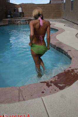 15P Amateur girl Addison St James frees her tiny tits from a bikini top in a pool