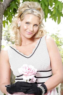 16P Blonde lady Phoenix Marie posing outdoors in retro dress and black gloves