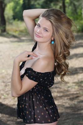 16P Young blonde Linden A highlights her tasty pussy while naked under tree cover