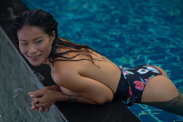 12P Asian model Maki Katana sports the wet look for a centerfold shoot