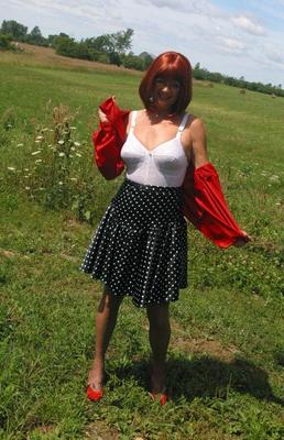 12P Natural redhead Miss Abigail wanders into field in her girdle and nylons