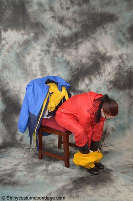 16P Pale redhead Lady Nadja dons a cleave gag while wearing rain suits