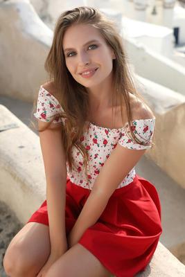 12P Pretty girl models fully clothed in a red skirt while on vacation