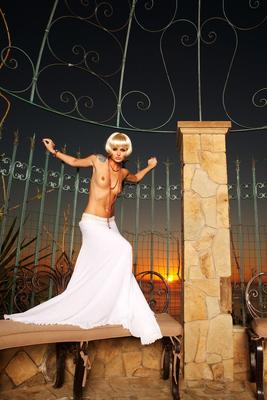 17P Elegant blonde centerfold shows medium tits seductively in the conservatory