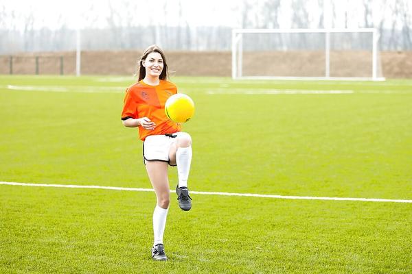 16P Lilly P is undressing her soccer uniform while on the field with a ball
