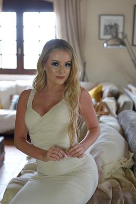 12P Blonde model Serenity slips off a tight dress to pose in a thong and heels