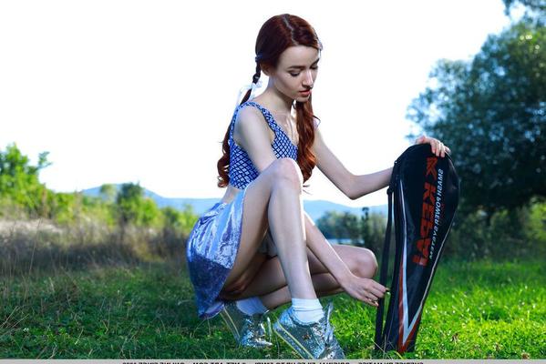 18P Young redhead Sherice pauses a badminton game to show her tight slit on grass