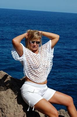 19P Blonde amateur Sweet Susi exposes her tits and ass on a rocks by the sea