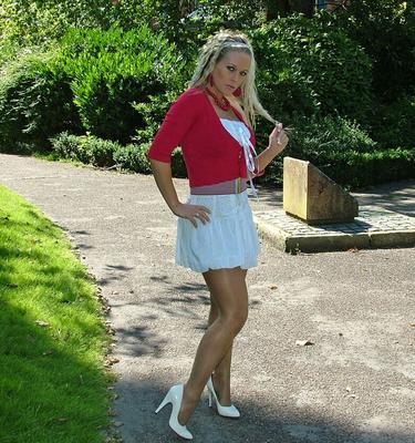 16P Hot blonde in short skirt flaunts her long legs in white heels at the park