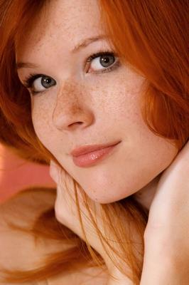 18P Redhead glamour model Mia Sollis posing in black lingerie in teasing manner