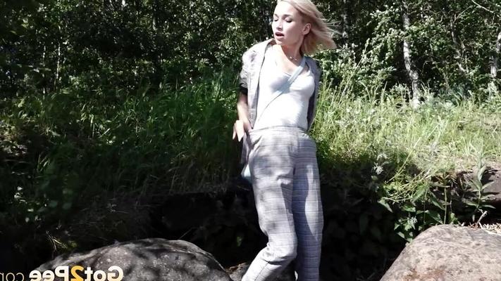 15P Blonde girl Masha squats for a piss between a couple of boulders