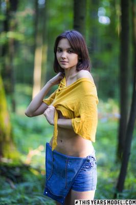 15P Skinny brunette Lara Masier gets completely naked in a mature forest
