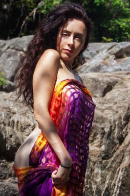 16P Busty model Madivya poses totally nude on wet rocks in a stream