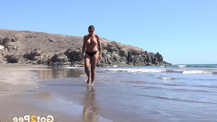 15P Big titted woman Chloe Lamour squats for a pee while walking on a beach
