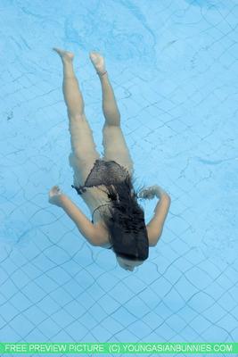 16P Young Asian girl with firm tits and a full bush swims naked in a pool