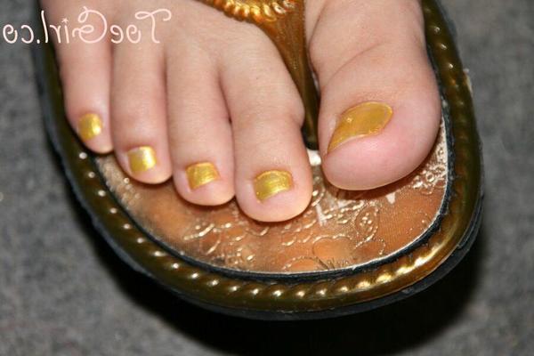 16P Caucasian female displays her painted toenails while wearing sandals