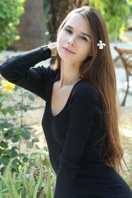 18P Leggy teen Leona Mia works clear of a black dress to pose nude in a garden