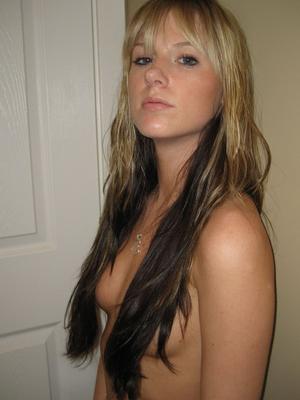 12P Blonde teen uncovers her perky boobs before starting to pull down her pants