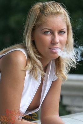 15P Natural blonde exposes her side boobs while having a cigarette on a balcony